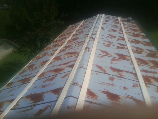 Rusted metal roof panels with new wood purlins before replacement — Storm Damage Roof Repair in Manly by Roofing Brothers