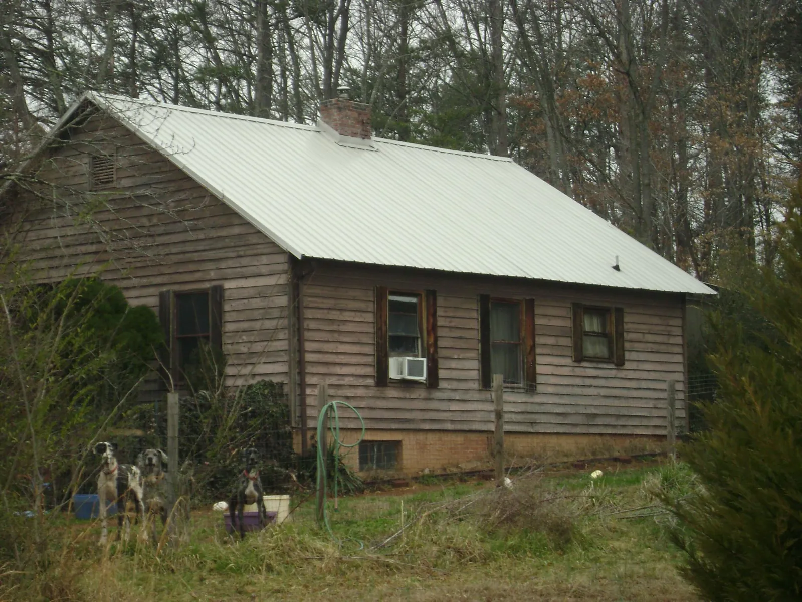 White metal roof on an old wood sided farmhouse, from a Metal Roof Installation job in Manly
